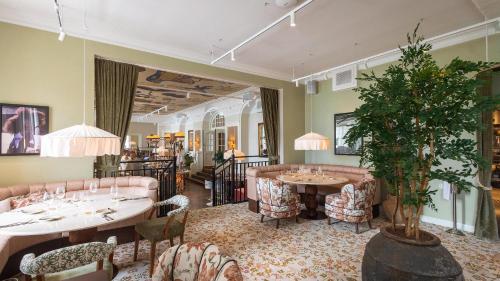 a restaurant with two tables and chairs and a plant at Maryhill Estate in Glumslöv