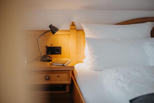 a bedroom with a bed and a night stand with a lamp at Salzbergalm in Berchtesgaden