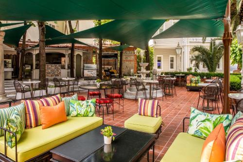 an outdoor patio with colorful furniture and tables at Hagia Sofia Mansions Istanbul, Curio Collection by Hilton in Istanbul