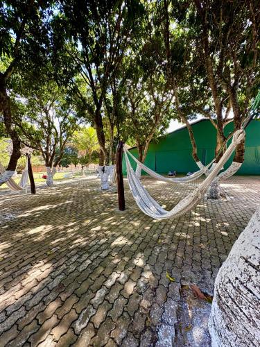 a hammock hanging from trees in a park at Dona Nilza Hotel Fazenda in Brasilia
