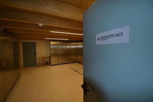 an empty room with aception set sign on a door at Residence Casa Federica in Valfurva