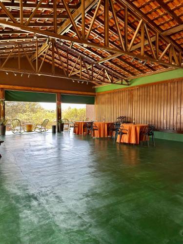 a large room with tables and chairs in it at Dona Nilza Hotel Fazenda in Brasilia