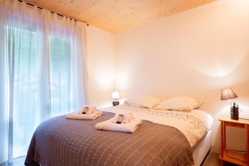 a bedroom with a bed with towels on it at La Ruinette-large1 Bed, Close To The Lift in Le Châble