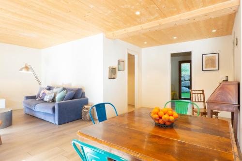 a living room with a table and a blue couch at La Ruinette-large1 Bed, Close To The Lift in Le Châble