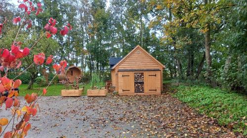 a small wooden dog house in a yard at Bed & Breakfast Voor De Wind in Slootdorp