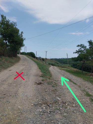 two arrows on a dirt road next to a dirt road at Quba Guest House in Digah