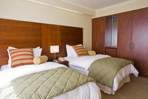 a hotel room with a bed and two nightstands at Hotel Stubel Suites & Cafe in Quito