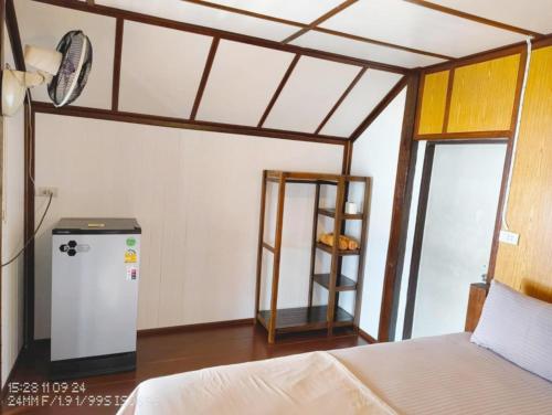 a room with a bed and a shelf in a room at Tao Thong Villa 2 in Ko Tao
