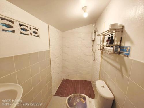 a small bathroom with a toilet and a sink at Tao Thong Villa 2 in Ko Tao