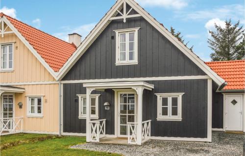 a black and white house with an orange roof at Blåvandslyst in Blåvand