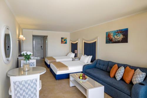 a living room with a couch and a bed at Beau Site Belle Vue Hotel in Marsa Matruh