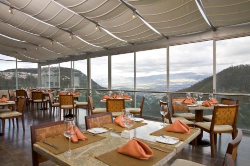 a dining room table with chairs and tables at Hotel Stubel Suites & Cafe in Quito