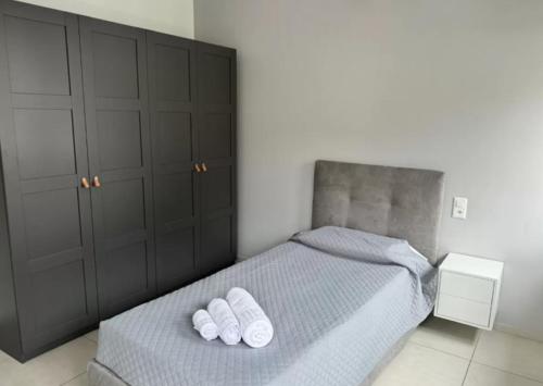 a bedroom with a bed with two white towels on it at Urban Residence by Quokka 360 - Apartments with parking in Lugano in Aldesago