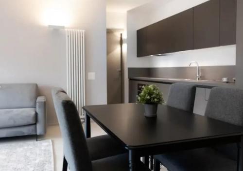 a living room with a table and a kitchen at Urban Residence by Quokka 360 - Apartments with parking in Lugano in Aldesago
