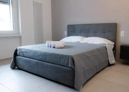 a bedroom with a large bed with towels on it at Urban Residence by Quokka 360 - Apartments with parking in Lugano in Aldesago