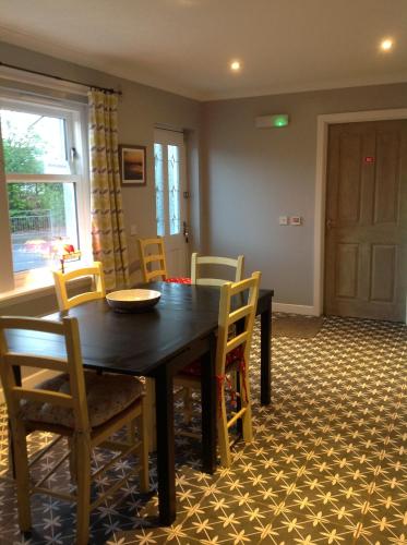 a dining room with a table and chairs at Saorsa House Culross in Fife