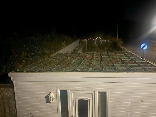 a white garage with a roof at night at Saorsa House Culross in Fife