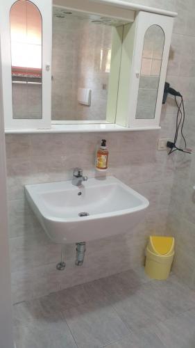 a bathroom with a white sink and two mirrors at Casa ATENA in Villa dʼAlmè