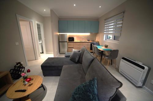 a living room with a couch and a table at Center Oasis Appartmens in Tirana