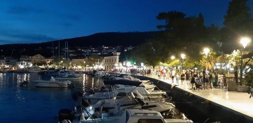 a group of boats docked in a marina at night at Oleander Apartments in Selce