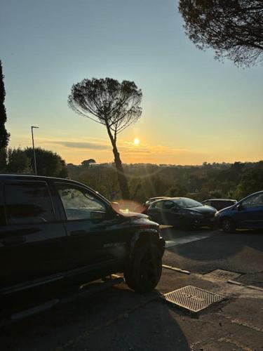 a car parked in a parking lot with the sun setting at Sweet Escape Roma in Rome