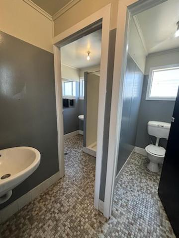 a bathroom with a sink and a toilet at Hotel Thangool in Thangool