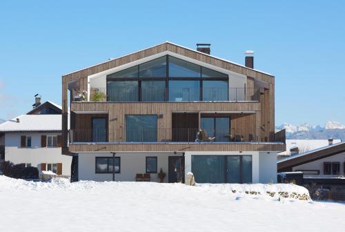 a house on top of a snow covered field at Ariala Apartments in Falzes