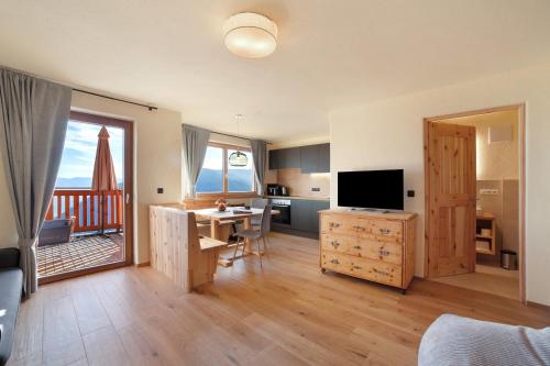 a living room with a kitchen and a dining room at Hauserhof in Lagundo