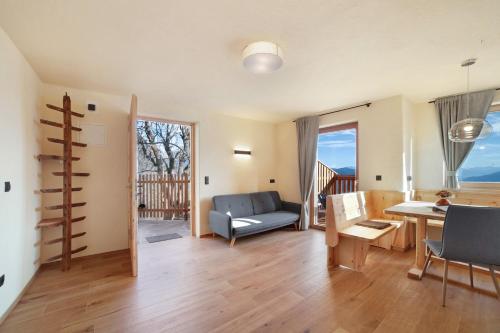 a living room with a couch and a table at Hauserhof in Lagundo
