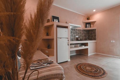 a kitchen with a refrigerator in a room at MORF suites in Casale Marittimo