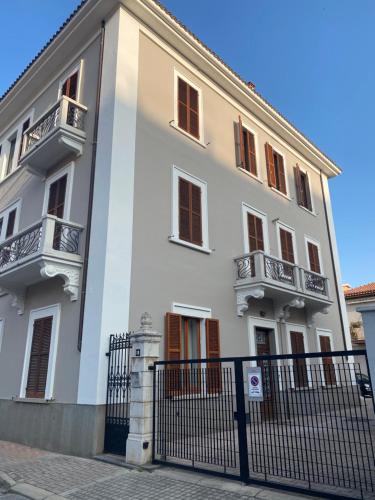a white building with balconies and a fence at WestHouse in Pescara