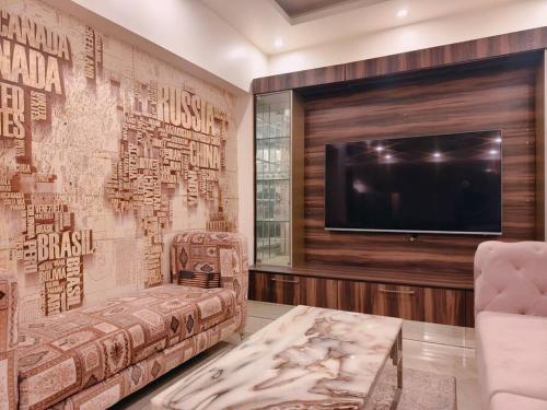 a living room with a couch and a tv at HostMyStay-3BHk ! Gk1 - RBlck! in New Delhi