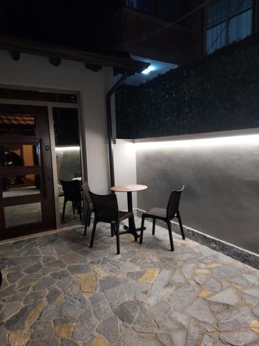 a table and chairs on a patio at night at Center Oasis Appartmens in Tirana