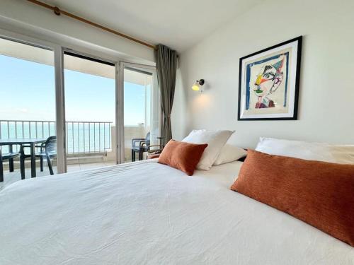 une chambre avec un lit avec vue sur l'océan dans l'établissement La petite Grenille, à Antibes