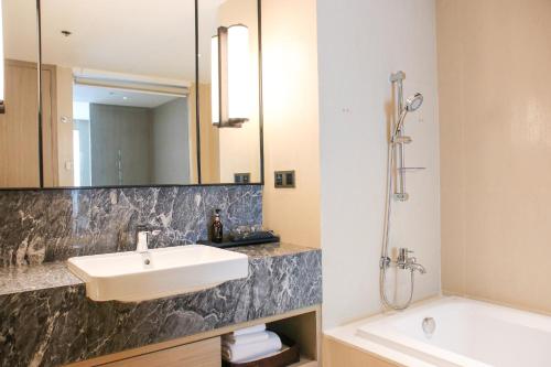 a bathroom with a sink and a mirror at Sivatel Bangkok Hotel in Bangkok
