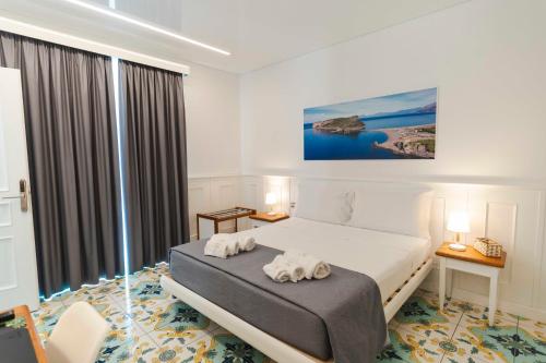 a bedroom with a bed with two towels on it at TEA Luxury - Praia a Mare in Praia a Mare