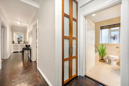 a hallway of a home with a toilet and a window at Welcome London Buckingham Palace in London
