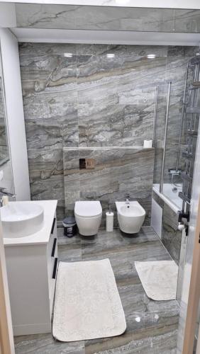 a bathroom with a sink and a toilet and a shower at AIRPORT 24&24 CAR PARKING in Chişinău
