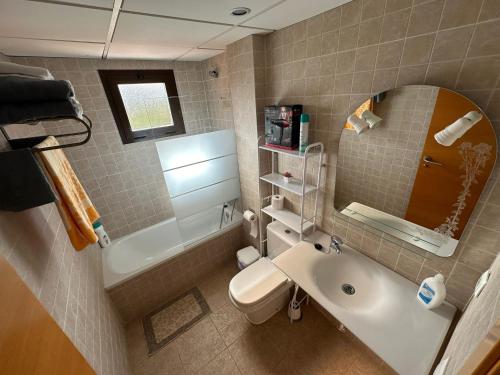 a bathroom with a sink and a toilet and a mirror at Secretos del Mar in Málaga