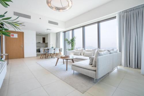 a living room with a couch and a table at RH - Beautiful Burj Khalifa View, 03BR with Maid's Room, 7 mins walk to Dubai Mall in Dubai
