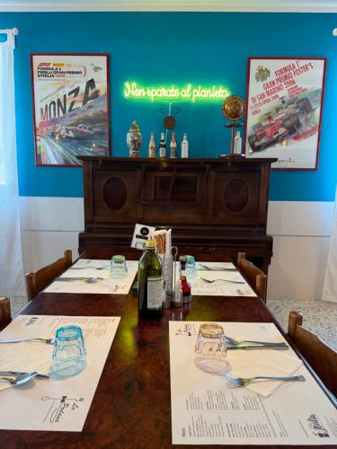 a table in a restaurant with a bottle of wine at Albergo La Padana in Montebello Vicentino