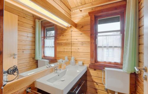 a bathroom with a white sink and a mirror at Ferienhaus Neckar 38 in Hayingen