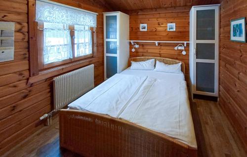 a bedroom with a bed in a wooden room at Ferienhaus Neckar 71 in Hayingen