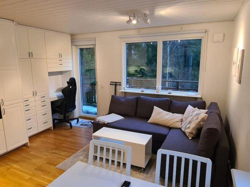 a living room with a couch and a table at A Tiny House in Norrby in Lanna-Drevviken