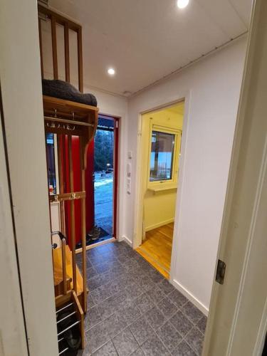 a hallway of a house with a room with a door at A Tiny House in Norrby in Lanna-Drevviken
