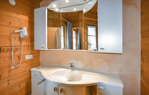 a bathroom with a sink and a mirror at Ferienhaus Tauber 60 in Hayingen