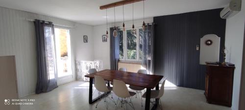 une salle à manger avec une table et des chaises en bois dans l'établissement Maison avec jolie vue, 5mn à pied du centre, à Sarlat-la-Canéda