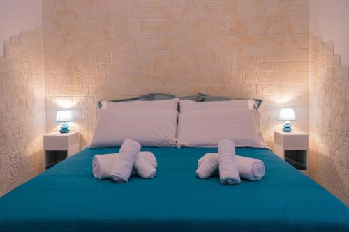 un letto con tre cuscini e due lampade di Rosalù - Vista mare a Polignano a Mare