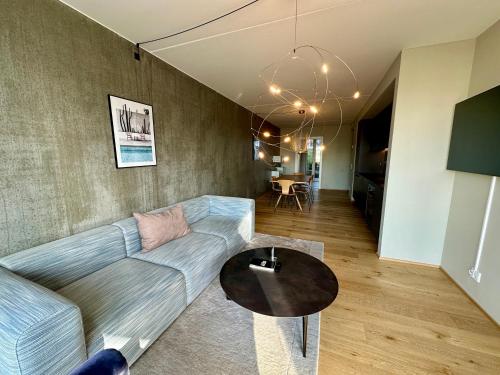 a living room with a couch and a table at STAY Nordhavn in Copenhagen