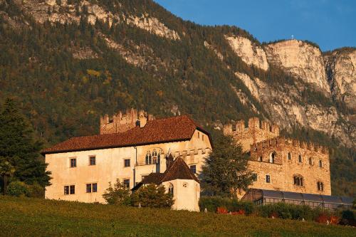 a large building in front of a mountain at Schloss Freudenstein in Appiano sulla Strada del Vino